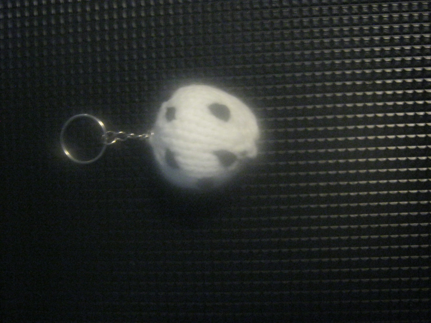 assortment of keyrings that are knitted or crocheted