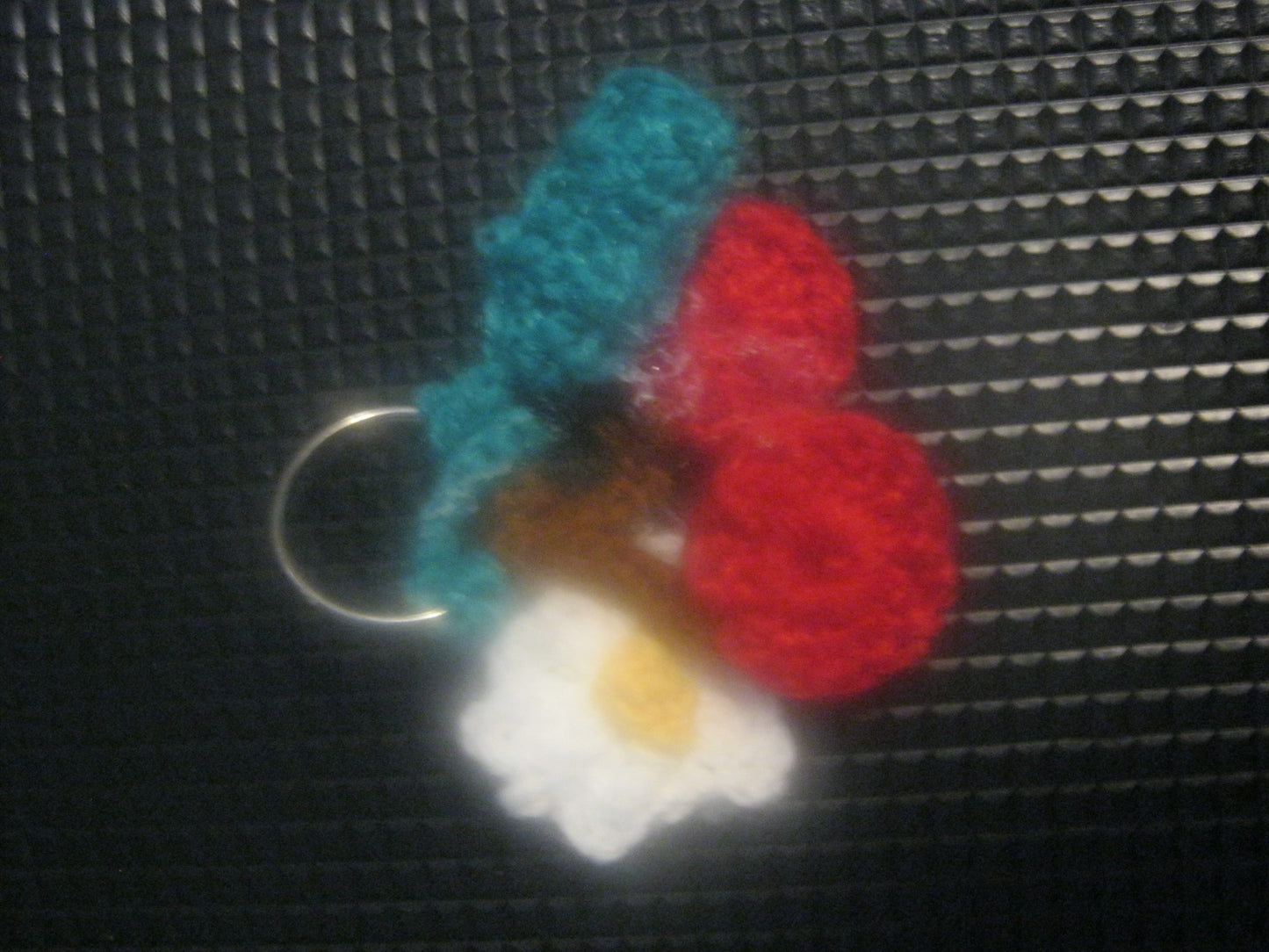 assortment of keyrings that are knitted or crocheted