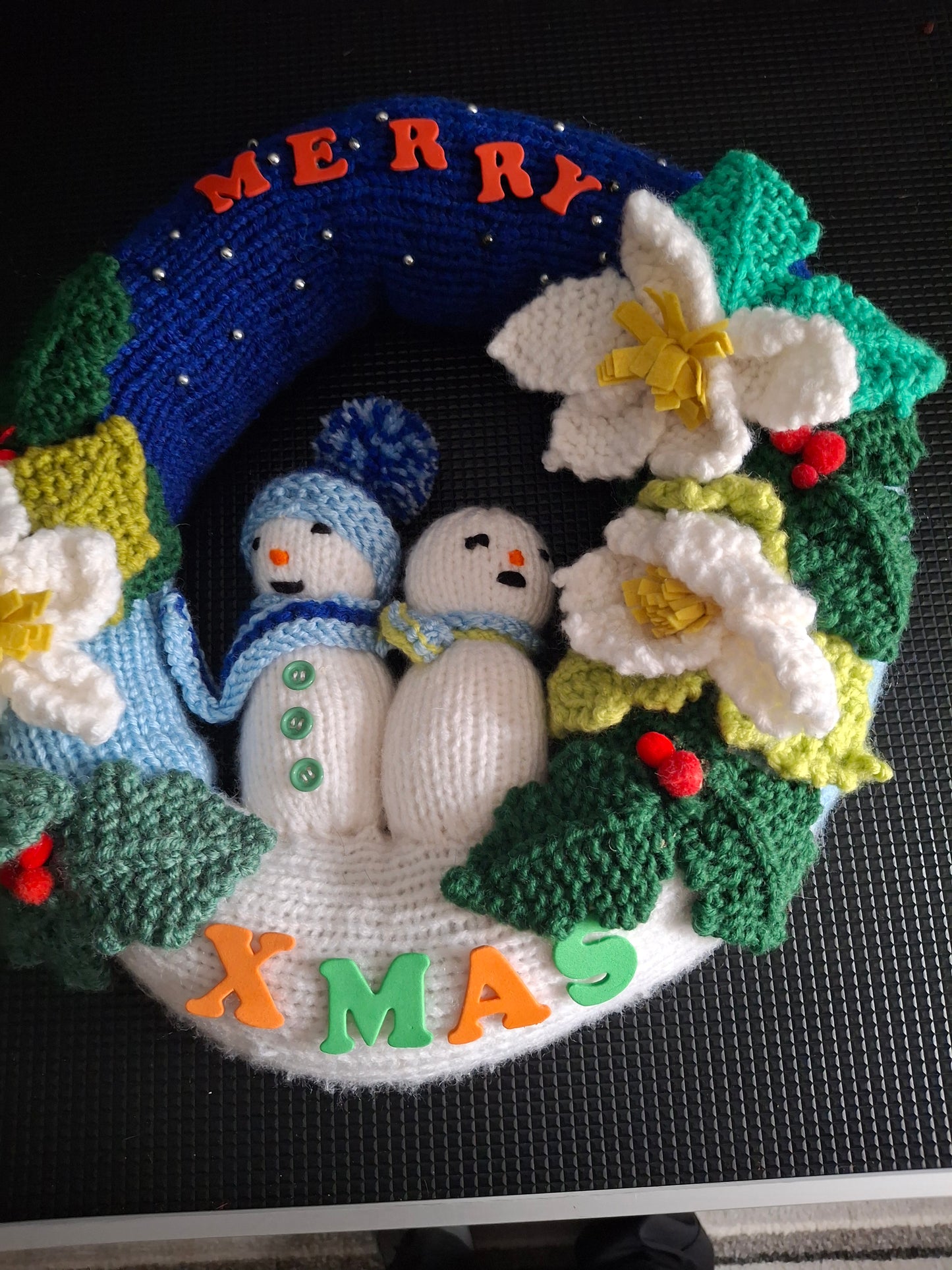 Christmas wreath with snowmen and flowers