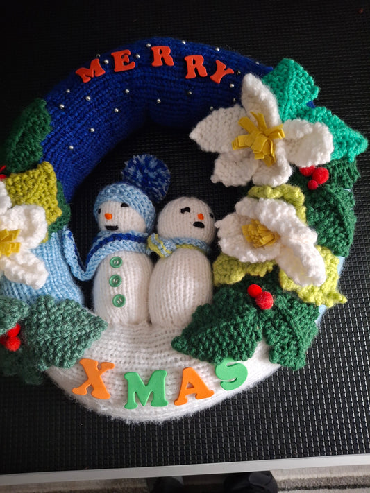 Christmas wreath with snowmen and flowers
