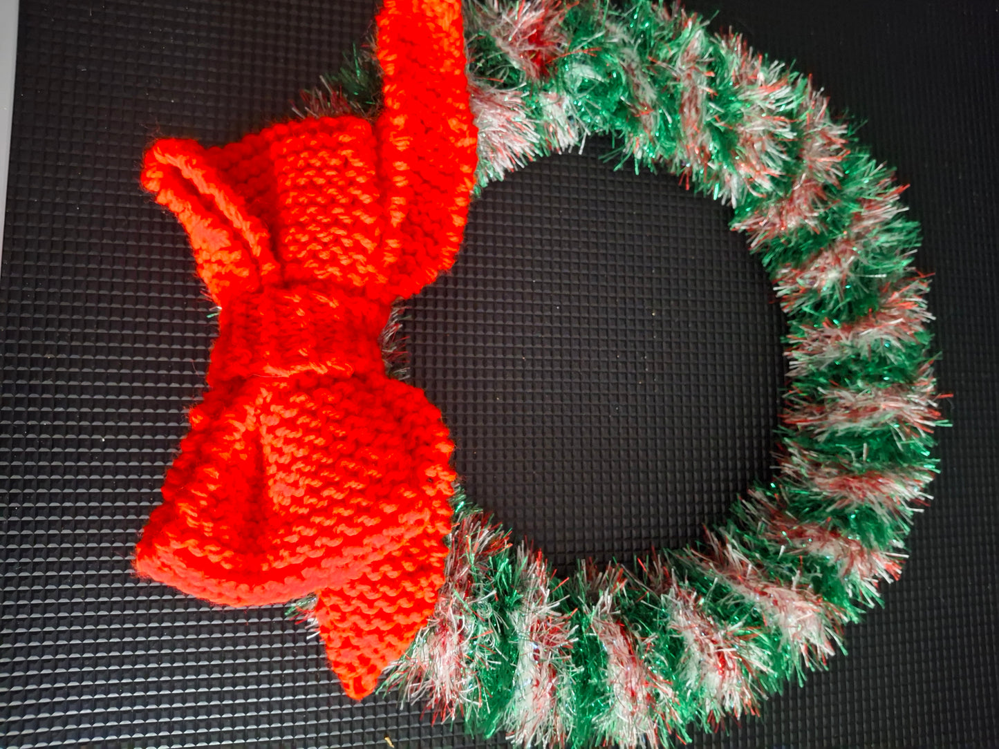 Christmas wreath knitted with knitted bow