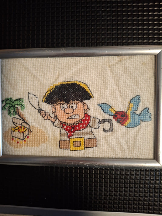 Pirate design cross stitched  in frame