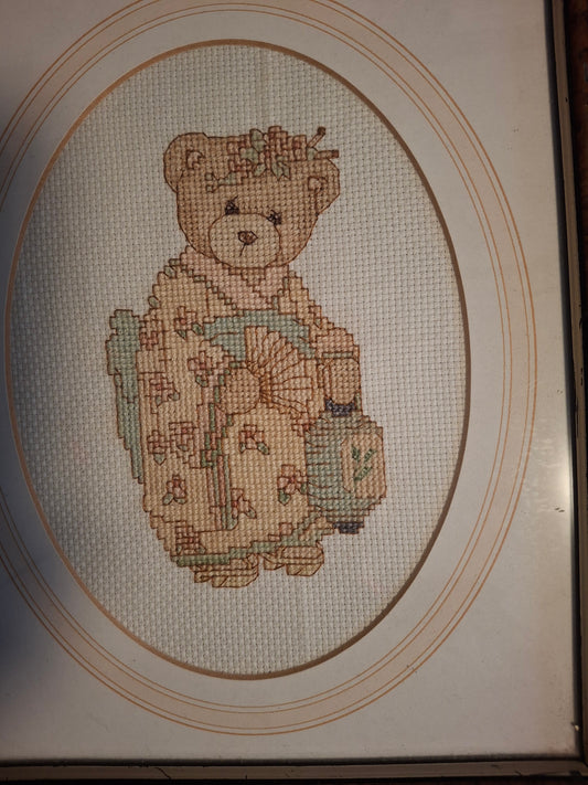 Cross stitched teddy bear in a picture  frame